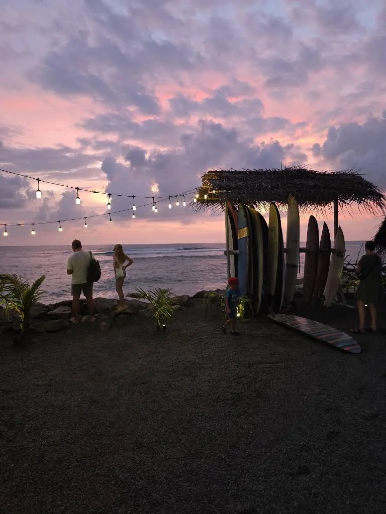 Sunset over the ocean and surfboards at The Gas Point, photo 5 of 6